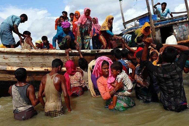 Rohingya refugees getting off a boat in Shah Porir Dwip, Bangladesh, on Monday. More than 300,000 Rohingya have poured into Bangladesh since Aug 25, adding to around 300,000 refugees already living in overflowing camps run by the United Nations in Co