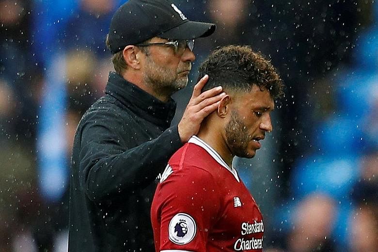 Liverpool manager Jurgen Klopp consoles Alex Oxlade- Chamberlain after the 5-0 defeat against Manchester City last Saturday.
