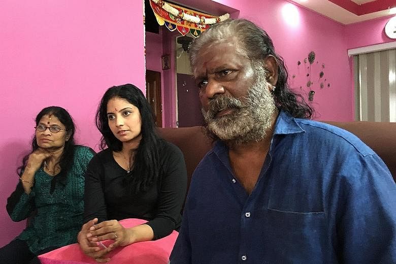 Mr S. Jaganathan with his wife and daughter. The veteran Hindu fire-walker is seeking costs for present and future medical expenses, loss of future earnings and compensation for pain, among other things.