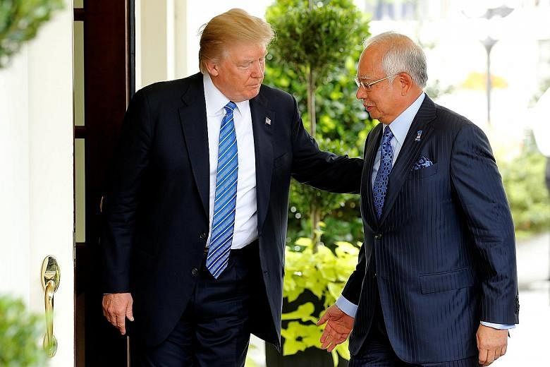 US President Donald Trump welcoming Malaysian Prime Minister Najib Razak to the White House in Washington yesterday.