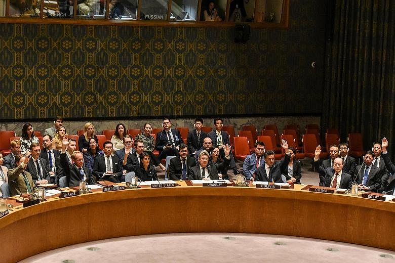 Ambassadors to the United Nations voting during a UN Security Council meeting on North Korea on Monday. The sanctions imposed against North Korea are watered down from an original draft by the United States, and stop short of choking off the regime's