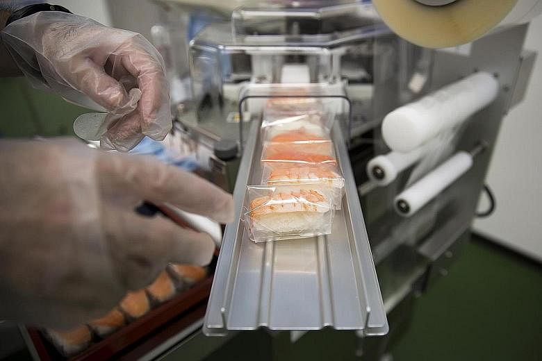 A machine dispenses sushi at the Suzumo Machinery Co factory in Kawashima, Saitama prefecture, Japan.