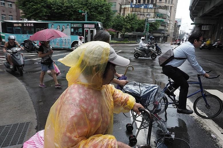 Wet weather in Taipei yesterday, ahead of the approach of Typhoon Talim. The storm is expected to slam into Taiwan's north and north-east today.