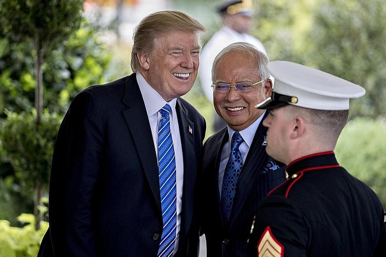 Mr Donald Trump greeting Mr Najib Razak on Tuesday, during the first visit by a Malaysian prime minister to the White House since 2004. Mr Najib had played golf at Mr Trump's course in Bedminster, New Jersey, some years ago, and the real estate tycoo