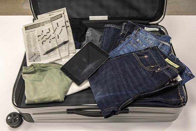 Stephen King's (above) travel essentials include his iPad, crossword puzzles and jeans.