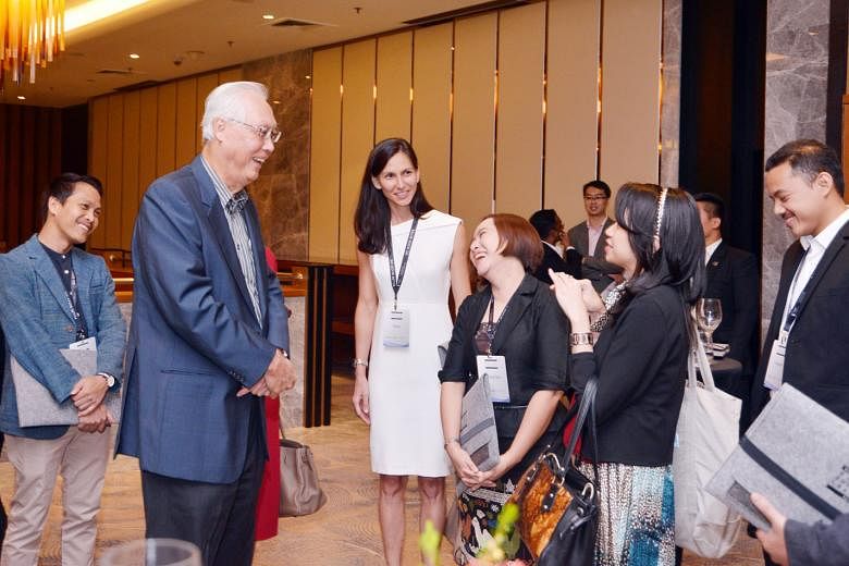 Emeritus Senior Minister Goh Chok Tong speaking with some participants of the inaugural Singapore Summit Young Societal Leaders Programme yesterday.