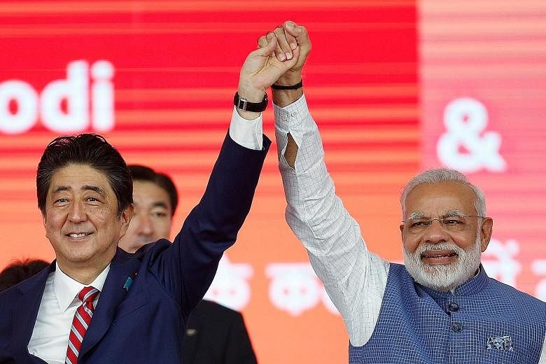 Japanese Prime Minister Shinzo Abe and his Indian counterpart, Mr Narendra Modi, after the ground-breaking ceremony for the high-speed rail project in Ahmedabad, India, yesterday. The $22.8 billion undertaking is expected to boost India's ageing rail