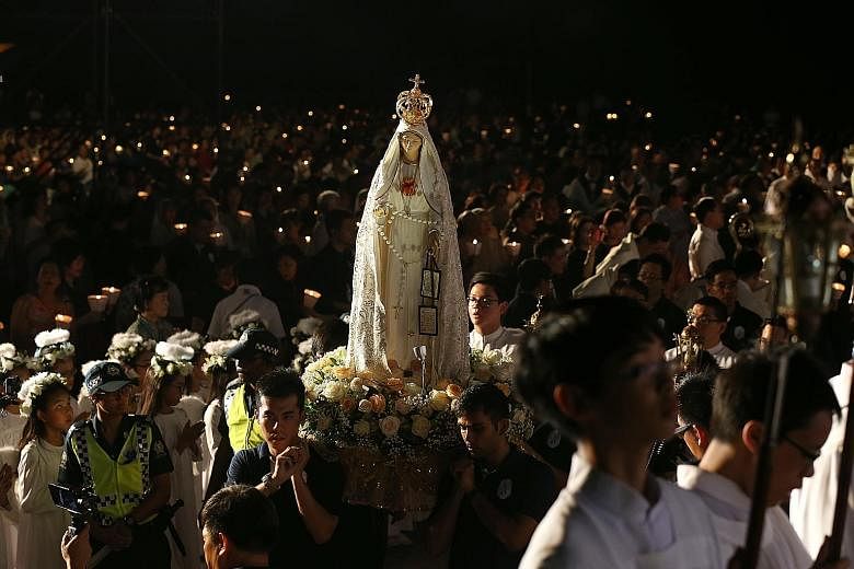About 5,000 people attended a mass at St Joseph's Institution on Wednesday, where a statue of the Blessed Virgin Mary, known as Our Lady of Fatima, was carried around the school field in a candlelight procession. Blessed by Pope Francis in January, t