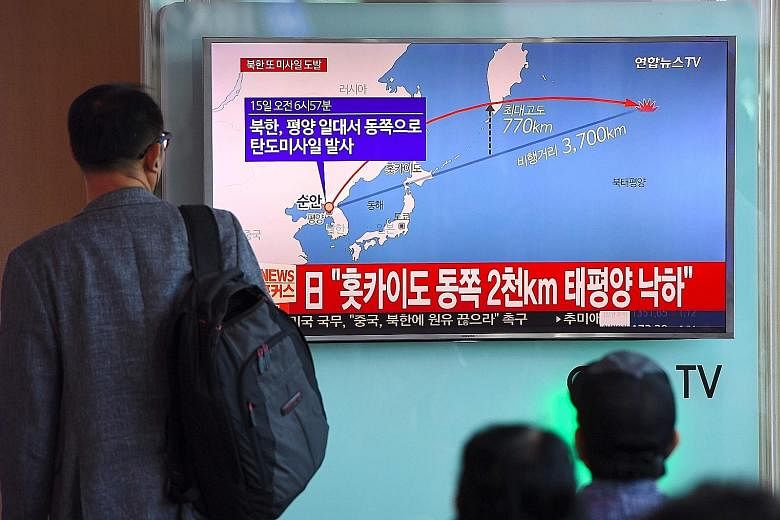 The North Korean missile launch being shown on TV in Seoul yesterday.
