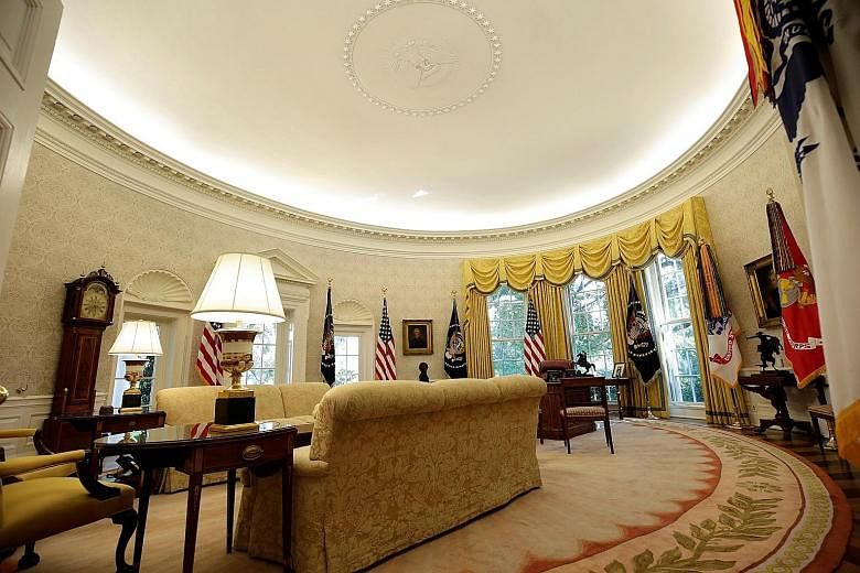 After a $4.6-million overhaul, the Oval Office's yellow candy-stripe wallpaper has been replaced with a creamy grey damask version, among other changes.