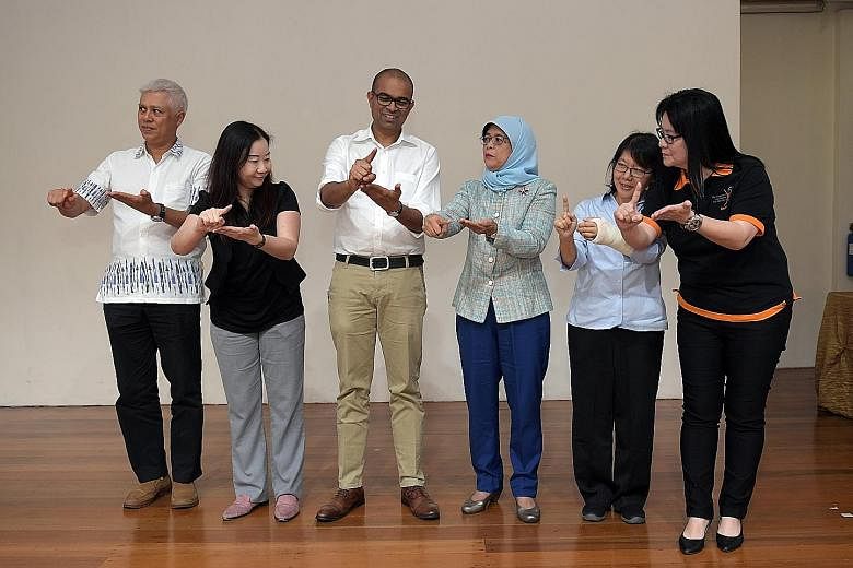 At the launch of the International Week of the Deaf at the Singapore Association for the Deaf in Mountbatten Road yesterday, (from left) Mr Marini Martin, vice-president of SADeaf; Ms Irene Yee, president of SADeaf; Dr Janil Puthucheary, Senior Minis