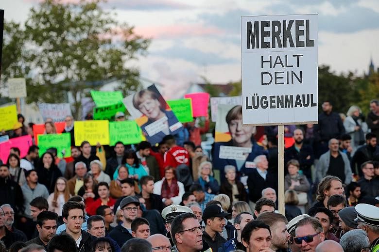 A poster reading "Merkel hold your lying mouth" at one of German Chancellor Angela Merkel's election rallies reflects the anger of voters ahead of next week's general election.