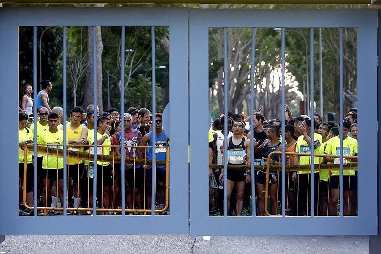 Left: Participants all set for the ninth edition of Yellow Ribbon Prison Run. Above: Mr Albert Silvaraj, who is now a coach for at-risk youth, with his wife Shanthi Nila and their son Jeron Mervin.