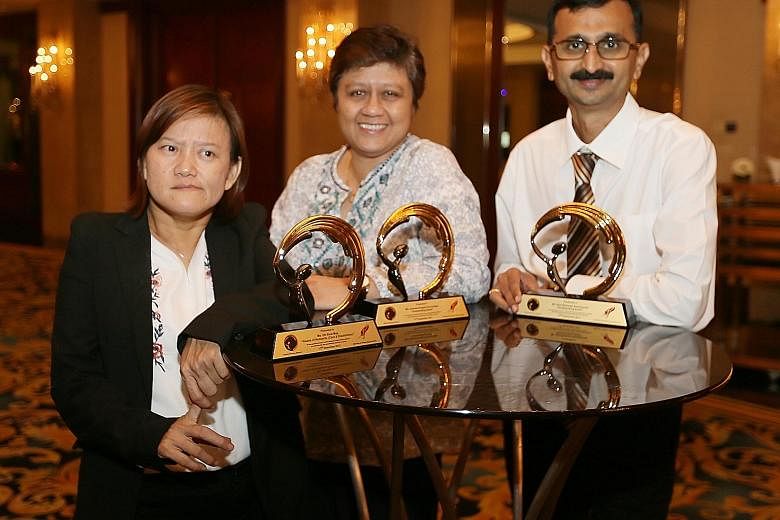 Silent Heroes Award recipients Oh Siew May, Gemma Angela Fernandez and Atul Ramesh Deshpande after the ceremony at Shangri-La Hotel last night. They were lauded for their contributions to society.