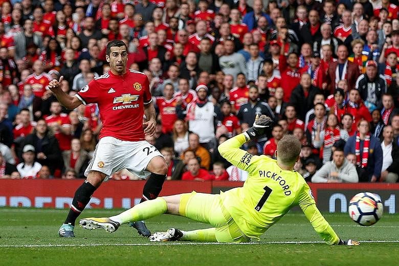 Manchester United's Henrikh Mkhitaryan slots home past Everton goalkeeper Jordan Pickford for their second goal. The Red Devils went on to net two more goals in the final two minutes.