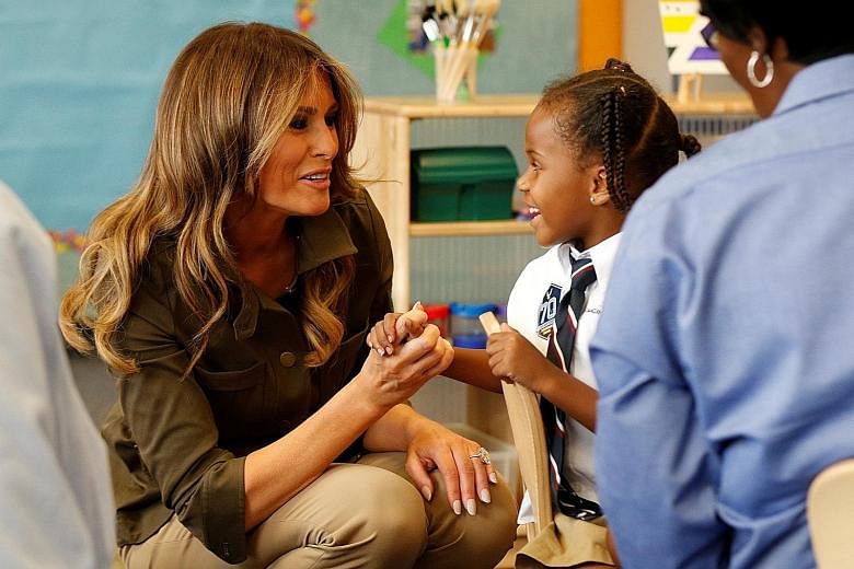 Mrs Melania Trump with a child at a youth centre at Joint Base Andrews in Maryland last Friday. She had travelled there in a show of support for military families. The United States First Lady is taking on a public schedule that is beginning to resem