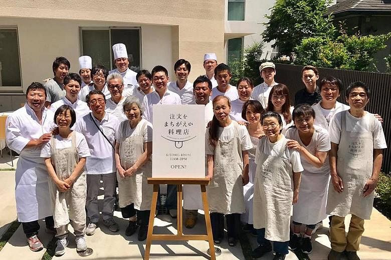 Organisers and wait staff at the first run of the Restaurant Of Order Mistakes in Tokyo in June. The idea behind the concept of the restaurant is to foster a spirit of tolerance, empathy and acceptance towards dementia patients.