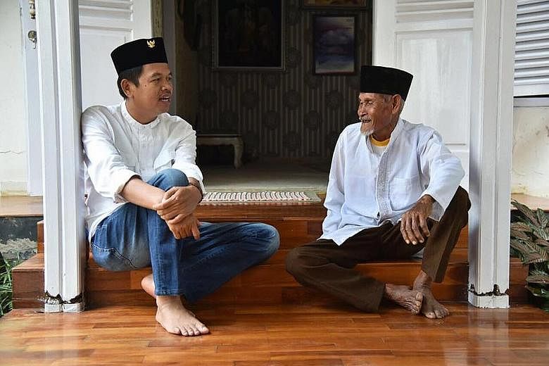 Purwakarta regent Dedi Mulyadi (left) with a local resident. Eager to put Indonesia back on track as a pluralist nation, he has won the support of its two largest parties in his run for governor.