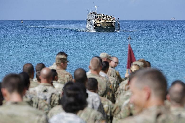 Soldiers from the 602nd Area Support Medical Company waiting on a beach for a Navy landing craft as their unit evacuates in advance of Hurricane Maria, in Charlotte Amalie, St Thomas, in the US Virgin Islands, on Sunday.