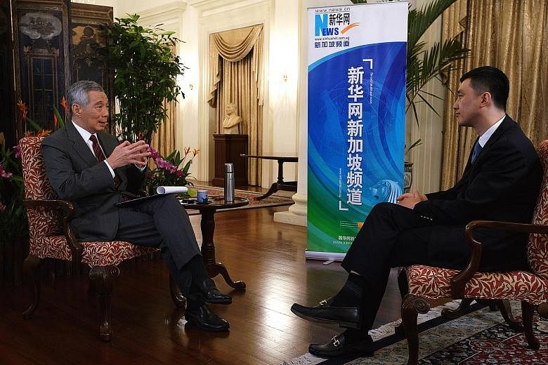 Prime Minister Lee Hsien Loong being interviewed by Mr Wu Lei, deputy general manager of Xinhua News Agency Asia-Pacific headquarters and general manager of Xinhuanet Singapore, at the Istana last Saturday.
