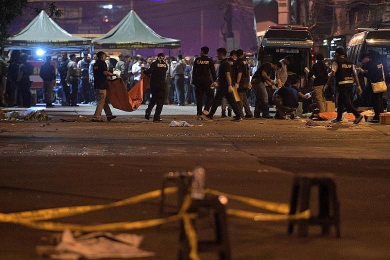 Police investigators at a bus station in Kampung Melayu, East Jakarta, on May 25, where two suicide bombers killed three policemen and injured more than 10 people.