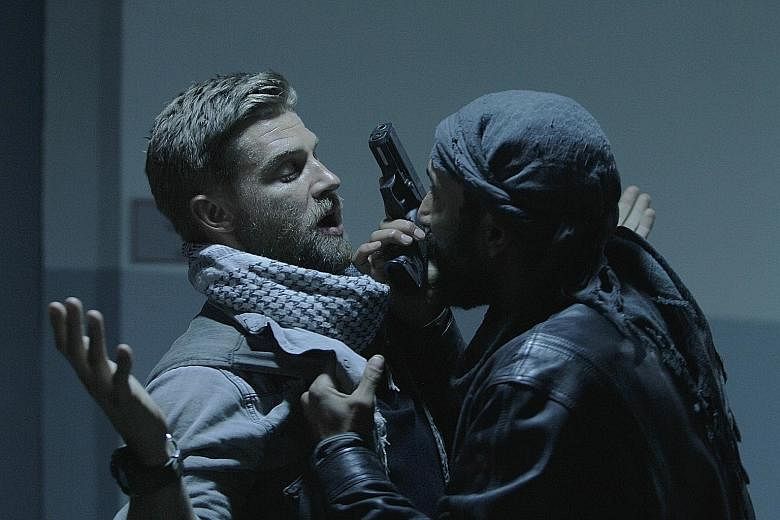 Mike Vogel (far left) stars as an officer leading a team on a mission to rescue a kidnapped eye surgeon in The Brave.