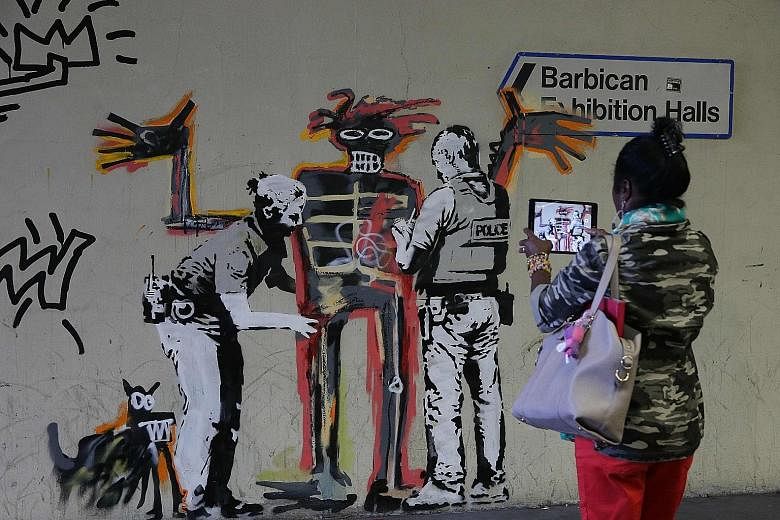 Street artist Banksy paid tribute to the late Jean-Michel Basquiat with two new murals at the Barbican Centre in London.