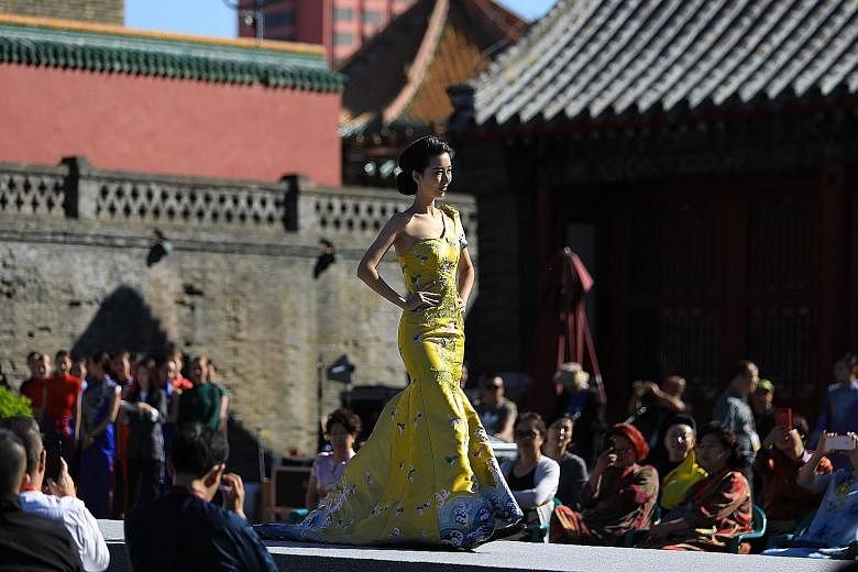 A model showing off an updated version of the cheongsam, also known as qipao, during the First Shenyang International Cheongsam Cultural Festival at Shenyang Imperial Palace, in China's north-eastern Liaoning province, yesterday.