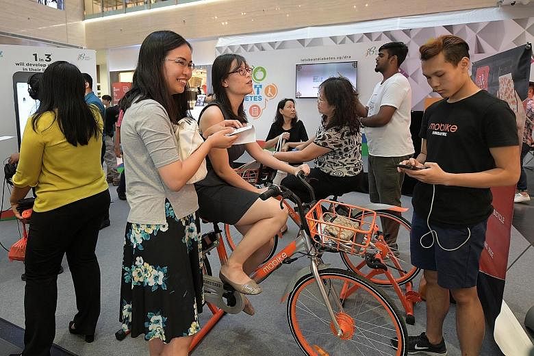 Members of the public who cycled for a minute at the Mobike counter at the roadshow yesterday received a $10 promo code and a free towel.