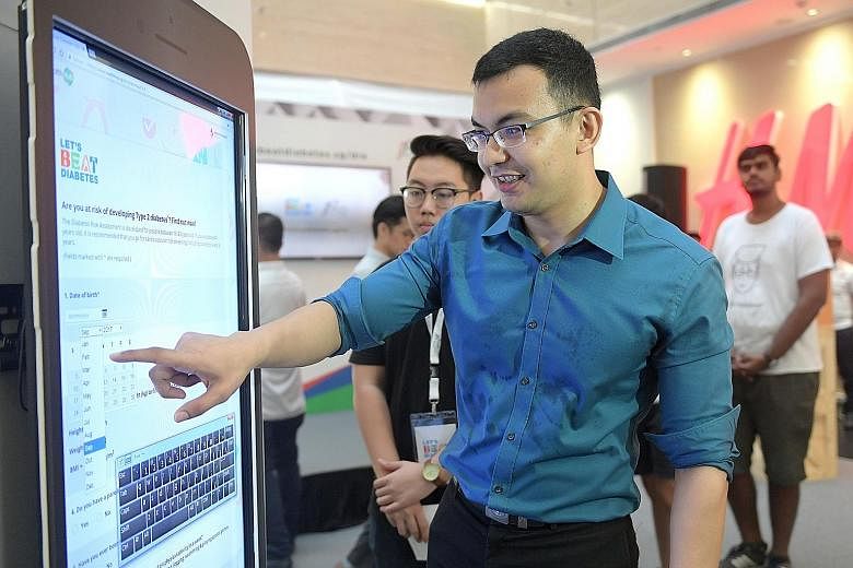 Analyst Herman Benny filling out the Ministry of Health's Diabetes Risk Assessment to determine if he is at risk of the disease at the Diabetes Risk Assessment Roadshow at One Raffles Place yesterday.