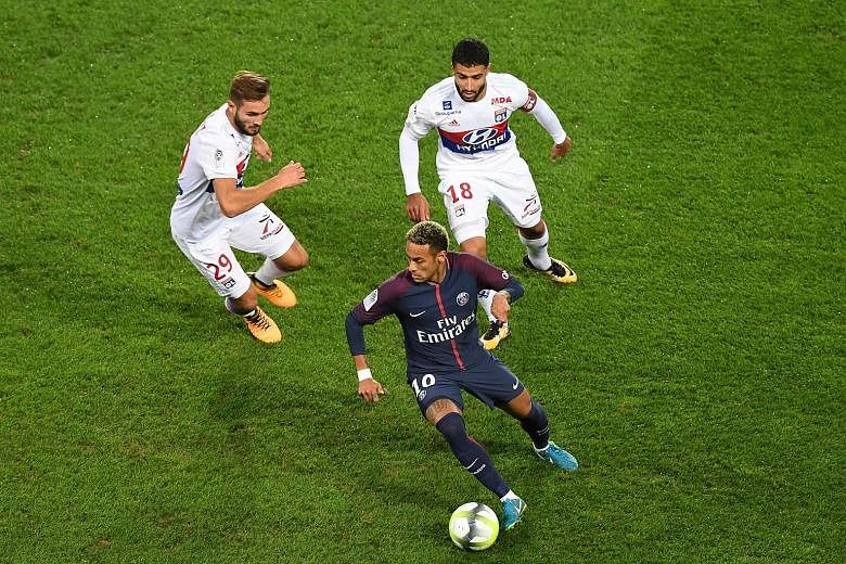 Neymar keeps Lyon midfielder Lucas Tousart (left) and forward Nabil Fekir at bay during Paris Saint-Germain's 2-0 victory on Sunday. PSG boss Unai Emery says he will intervene only if the Brazilian and Edinson Cavani cannot sort out their differences