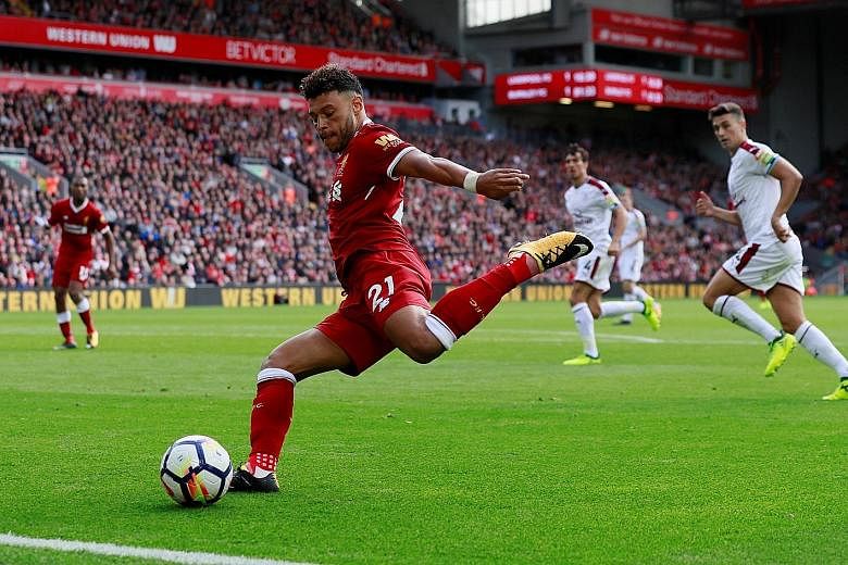 Alex Oxlade-Chamberlain preparing to deliver a cross in the Premier League game against Burnley after coming on as a substitute for Roberto Firmino.