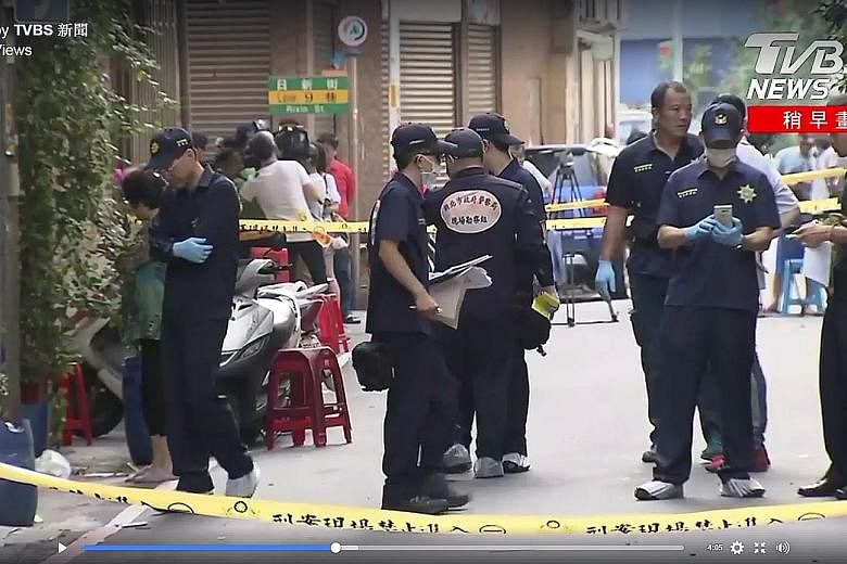 Taiwanese police at the scene of the shooting incident yesterday. The suspect said he was seeking revenge for his "boss".