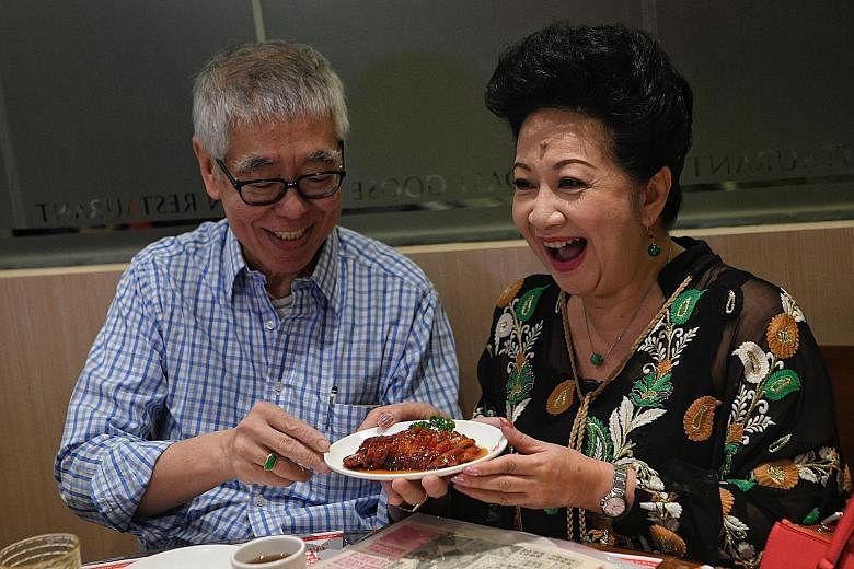 Robert Chua presenting actress Nancy Sit with the Kam's Roast special Iberico Char Siu to commemorate their 50 years of friendship at the restaurant in Singapore, which he brought in.