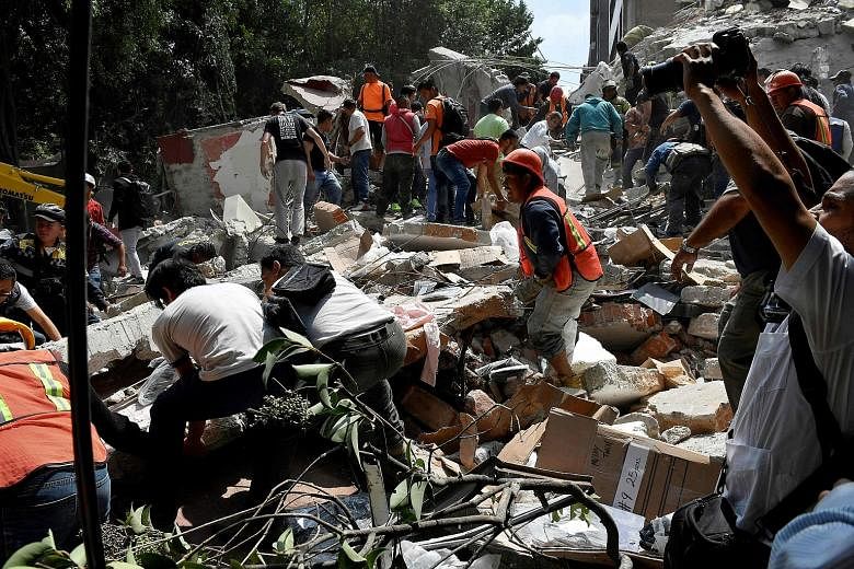 People searching for survivors after the quake in Mexico City on Tuesday. The disaster struck on the 32nd anniversary of a deadly 1985 quake.