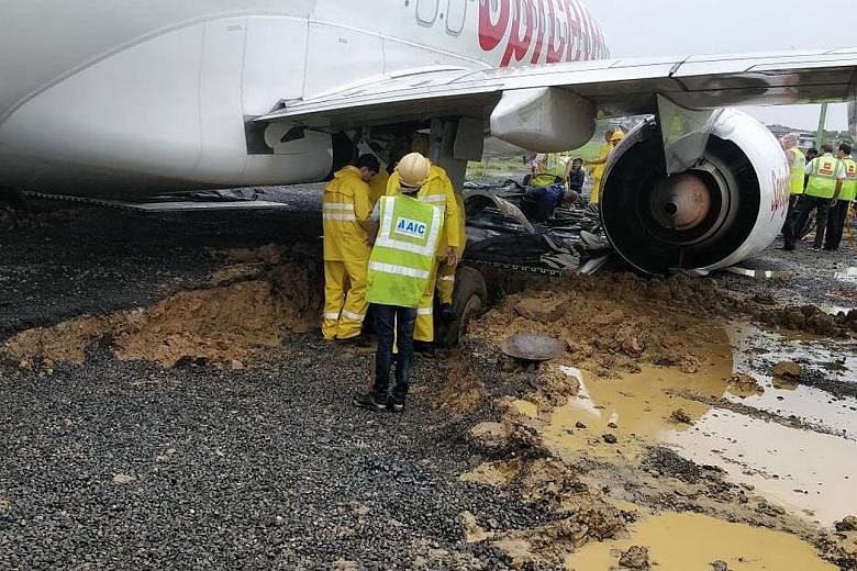 A SpiceJet plane overshot the runway at Mumbai's airport on Tuesday night and became stuck in the mud as heavy rains hammered the city for the second time in less than a month. Unabated construction and rubbish-clogged drains and waterways have made 