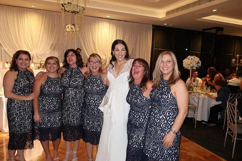 Bride Julia Mammone with the women who turned up in the same lace pencil dress, including Ms Debbie Speranza (in glasses). The dress sells for A$159.99 (S$173) on Forever New's website.