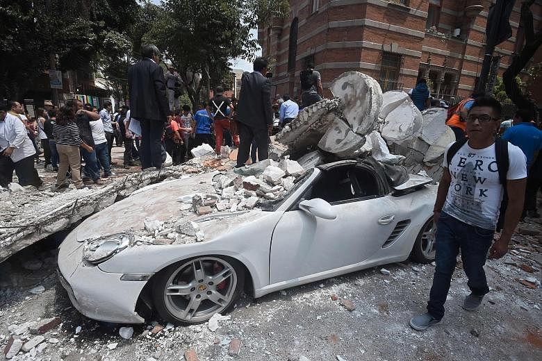 Rescue efforts at a flattened building in Mexico City on Tuesday after the powerful quake caused dozens of buildings to topple, tore gas mains and set off fires across the city and other towns. A collapsed building in the Condesa neighbourhood in Mex