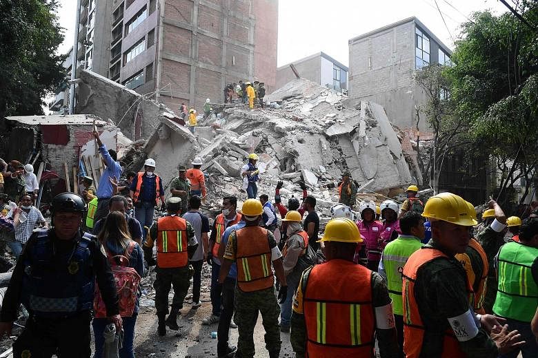 Rescue efforts at a flattened building in Mexico City on Tuesday after the powerful quake caused dozens of buildings to topple, tore gas mains and set off fires across the city and other towns. A collapsed building in the Condesa neighbourhood in Mex