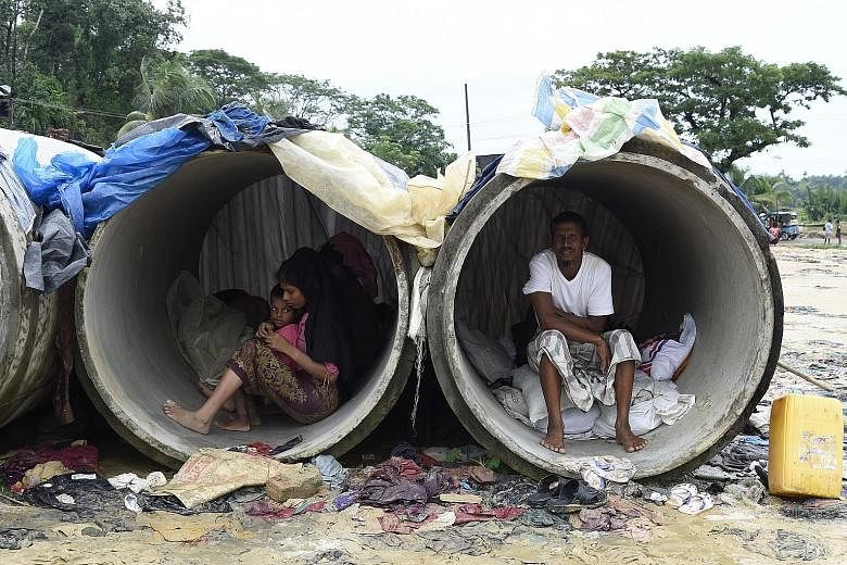 Rohingya Muslim refugees sheltering in cement pipes at Kutupalong refugee camp in the Bangladeshi district of Ukhia yesterday. Myanmar leader Aung San Suu Kyi on Tuesday condemned rights abuses in Rakhine state, where conflict that began last month h