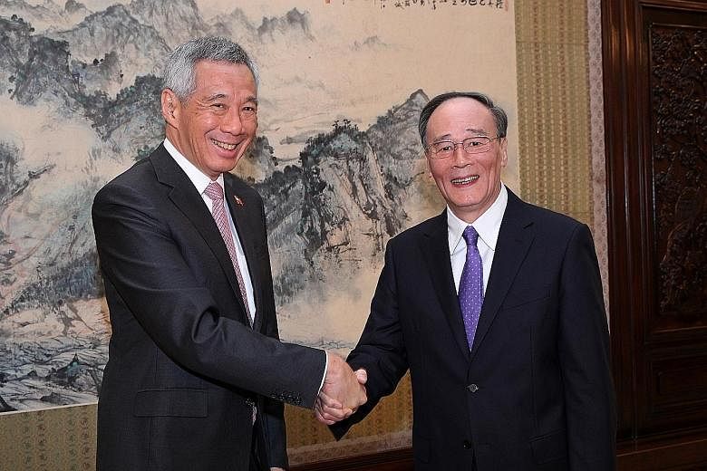Prime Minister Lee Hsien Loong meeting Mr Wang Qishan, head of the CCP's Central Commission for Discipline Inspection, at the Zhongnanhai leadership compound in Beijing yesterday.