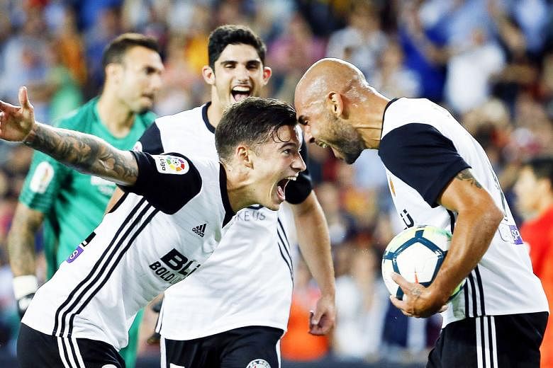 Italian striker Simone Zaza (right) celebrating his hat-trick against Malaga with team-mate Santi Mina. Valencia have endured two tumultuous seasons in a row but it appears the Spanish sleeping giants are awakening.