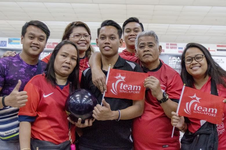 S'pore bowler Muhammad Farhan Ismail with his family after winning the TPB4 gold at the APG. He bowls with his family occasionally and also hits the lanes with his former schoolmates.