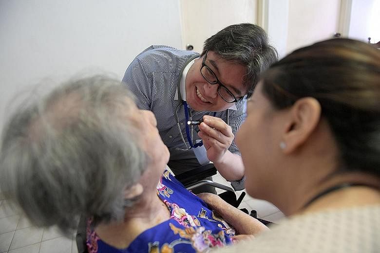 Dr Erwin Francisco, resident physician at Dover Park Hospice, and staff nurse Zhao Meijuan attending to Mrs Monica Fernandez in her own home. Since joining Programme Dignity last year, Mrs Fernandez and her daughter, who cares for her, have not neede