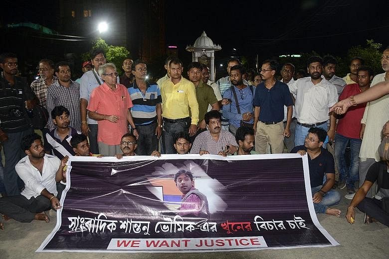 Indian journalists at a road blockade, set up over the killing of fellow reporter Shantanu Bhowmick on Wednesday, in front of the Chief Minister's residence in Agartala, the capital of the north-eastern state of Tripura.