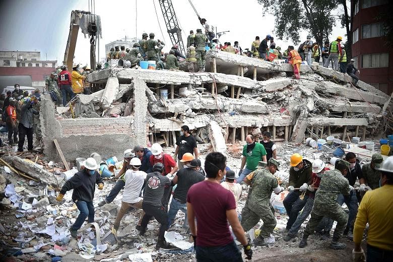 Rescuers, firefighters, policemen, soldiers and volunteers searching for survivors in a flattened building in Mexico City on Wednesday, a day after a strong quake hit central Mexico. In an outpouring of sympathy, thousands of volunteers from all walk