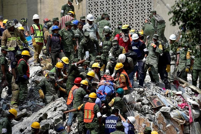 A man pulled out of the rubble alive in Mexico City on Wednesday, a day after a 7.1-magnitude earthquake rocked central Mexico.