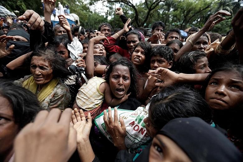 Rohingya refugees at Cox's Bazar in Bangladesh struggle to get aid handouts.