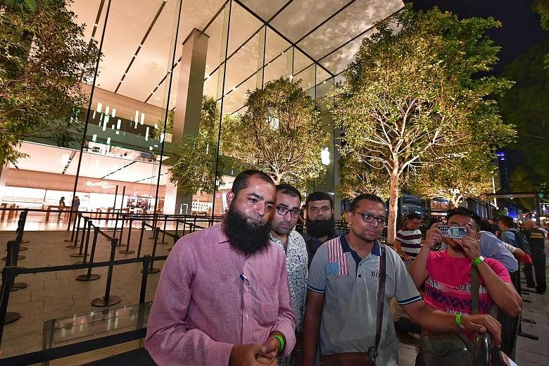 Mr Amin Ahmed Dholiya was first in the queue, having arrived at the store at around 7pm on Thursday. It was his first time queueing overnight for something, he said. He returned home last night. The queue outside Apple Orchard Road at 7.32am yesterda