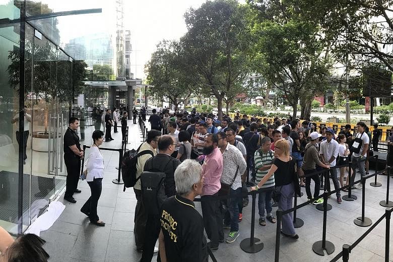 Mr Amin Ahmed Dholiya was first in the queue, having arrived at the store at around 7pm on Thursday. It was his first time queueing overnight for something, he said. He returned home last night. The queue outside Apple Orchard Road at 7.32am yesterda